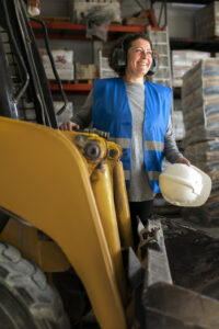 professional female driver operating forklift vehicle