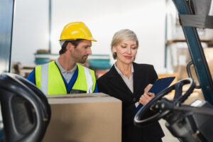 warehouse manager talking with forklift driver